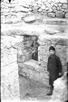 A boy in the excavated room of the so-called mint. 1904